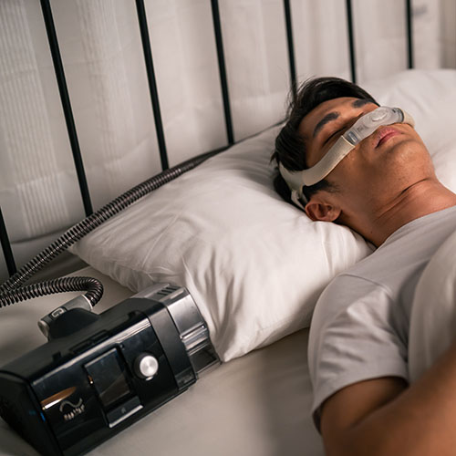 Asian man wearing cpap machine sleeping smoothly all night in be